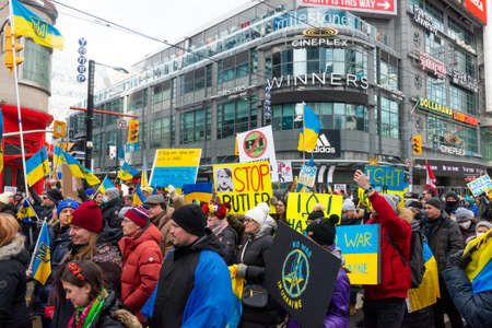Toronto, Ontario, Canada â February 27, 2022:  Protestors with banners and Ukrainian flags in Downtown Nathan Phillips Square during a demonstration against Russian invasion in Ukraineのeditorial素材