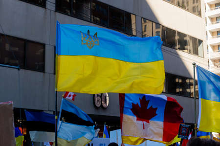Toronto, Ontario, Canada â March 6, 2022:  Demonstrators with yellow and blue Ukraine flags and anti-war signs near Russian consulate in Toronto ask to close the airspace over Ukraine during the war in Ukraineのeditorial素材