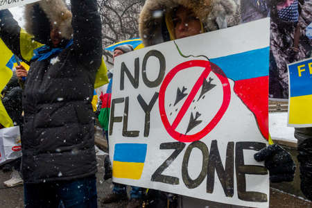 Toronto, ON, Canada â April 10, 2022:  Protestors with banners and Ukrainian flags in Downtown Nathan Phillips Square during the  rally to stop the genocide of Ukrainians.のeditorial素材