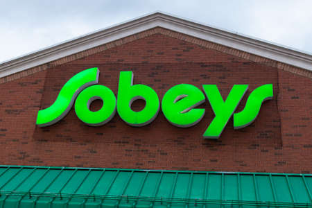 Toronto, ON, Canada - December 08, 2021: View at the brand identity sign over the entrance of a...