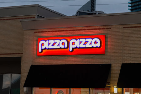 Toronto, ON, Canada â August 20, 2023: View at the sign of Pizza Pizza Company in Ontarioのeditorial素材