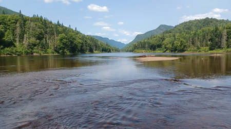 View at the Jacques Cartier lake in Quebec with reflects in the clear water, showcasing summer...