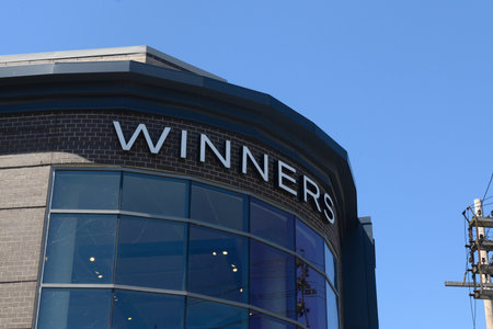 Toronto, ON, Canada - July 26, 2024: View at the brand identity sign over the entrance of a Winners discount fashion store in a shopping mall in Toronto.のeditorial素材