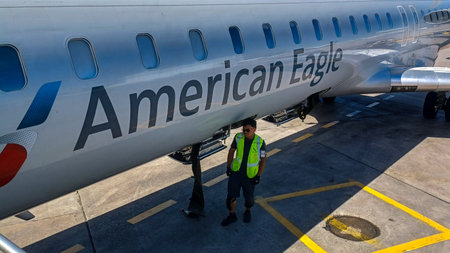 Toronto, ON, Canada - August 30, 2025: An American Eagle airplane stands on the tarmac as ground...