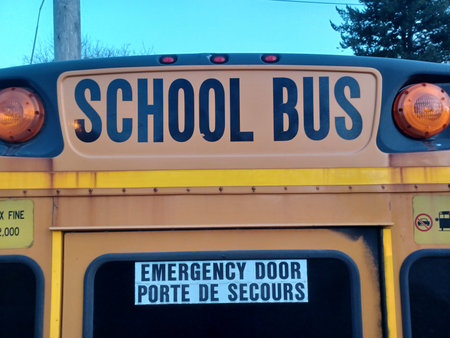 Toronto, ON, Canada - September 25, 2025: The back of a classic yellow school bus displays the bold...