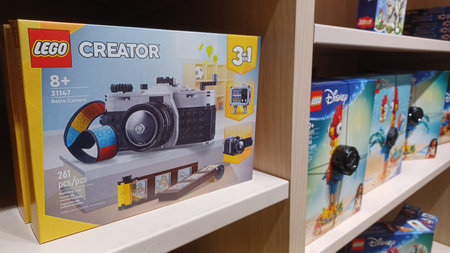 Toronto, ON, Canada - January 5, 2026: Various leveled readers and picture books sit on wooden shelves in a bright library or shop.のeditorial素材