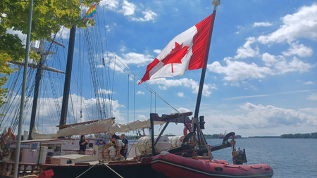 Toronto, ON, Canada - August 25, 2025: A Canadian flag flies from a tall ship docked at the waterfront on a bright and sunny day.のeditorial素材