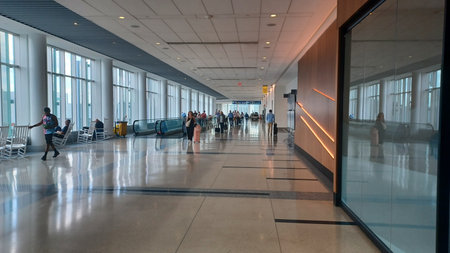 Charlotte, NC, USA - June 9, 2025: The airport is full of passengers passing the time between flights.のeditorial素材