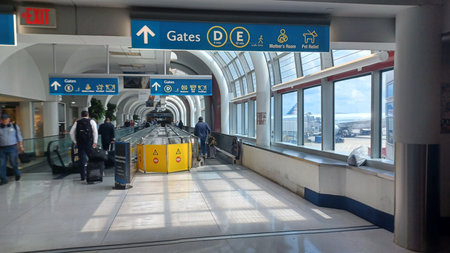 Charlotte, NC, USA - June 9, 2025: Passengers use the moving walkway in Charlotte Douglas International Airport to get to their gates faster.のeditorial素材