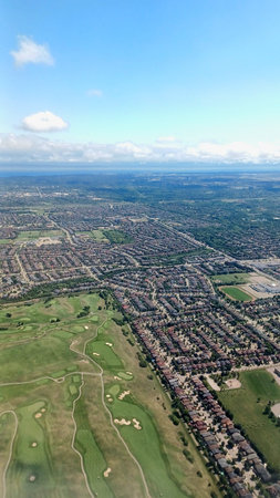 Toronto, ON, Canada - August 29, 2025: The image shows an aerial view of Toronto with its suburbs and a golf course, taken from an airplane.のeditorial素材