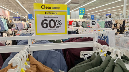 Toronto, ON, Canada - December 10, 2025: A 60% off clearance sign hangs above family outerwear at a...