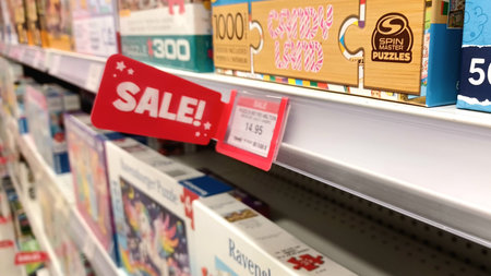 Toronto, ON, Canada - December 10, 2025: A sale sign highlights discounted puzzles on a shelf,...