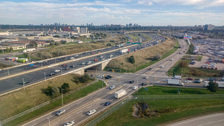 Toronto, ON, Canada - October 10, 2025: The highway stretches with visible city skyline in this...