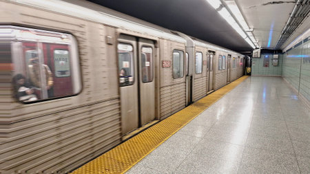 Toronto, ON, Canada - March 26, 2026: A subway train is speeding through the station platform,...