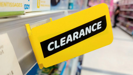 Toronto, ON, Canada - December 10, 2025: A clearance sign indicates discounted items in a store aisle, offering a chance to save money.