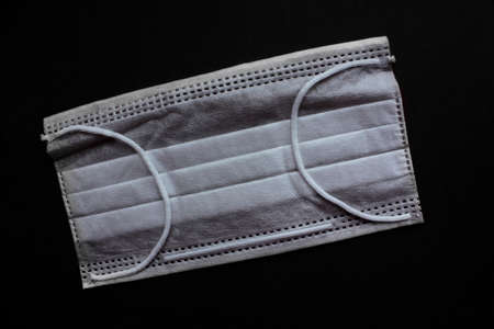 Medical mask for virus protection. Disposable mask. Black background.の写真素材