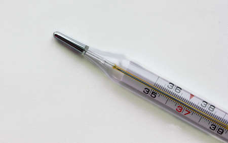 Mercury thermometer. Thermometer shows a high temperature. Located in the left bottom corner. White...