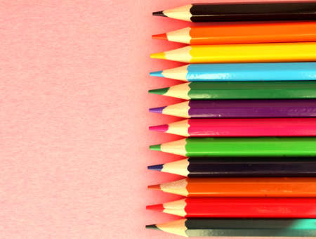 Colored pencils on pink background. Lots of different colored pencils. Colored pencil. Pencils...