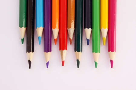 Colored pencils on a white background in staggered order. Lots of different colored pencils. Colored pencil. Pencils are sharp. Pencils are on top. Close-up. Copy space. Background. Flat layの写真素材