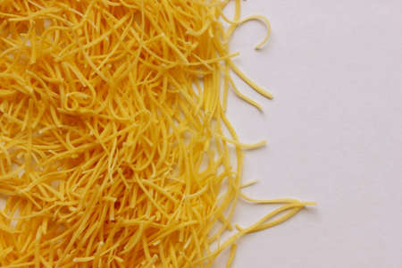 Small layer of dry noodles. The food background is the texture of the paste. Homemade noodles....