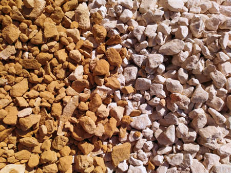 Beautiful yellow-beige gravel in bright. A place for text. Background. Texture. Yellow and white...