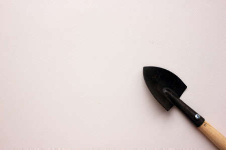 Garden tools, shovel isolated on a white background. Close-up. The concept of planting rasta, agriculture, transplantation of houseplants, working tools. Hobby. Flaty. Copy spaceの写真素材