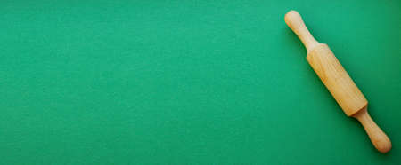 A rock for a test made of wood on a green background. Cooking and baking. cookery. View from above....