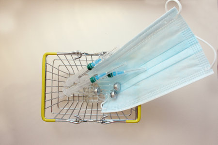 Basket with ampoules of medicines for injection, spri, medical mask. vaccination. The concept of medicine and immunity. Vaccination against viral infections. Drug and injection. cold. Injection, drug.の写真素材