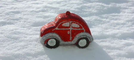 Christmas tree toys in the form of a red car on a white background. Christmas and New Year. Toys on the Christmas tree. Childhood. Copy space. New Year is decoration, symbol, gift. Gift. Bannerの写真素材