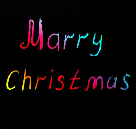 Greeting Christmas is card on a black background in colored letters. Marry Christmas. Holiday, words, letters.の写真素材