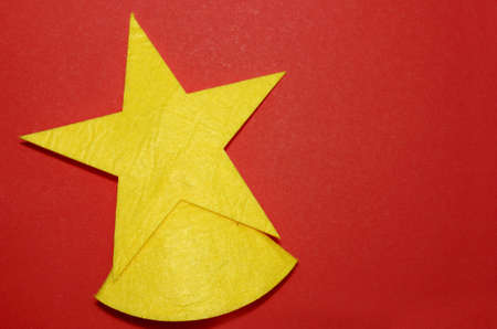Christmas tree toys on a red background. Toy in the form of a star. Top view. Christmas and New Year. Toys on the Christmas tree. Childhood. Felt toys. Copy space.の写真素材