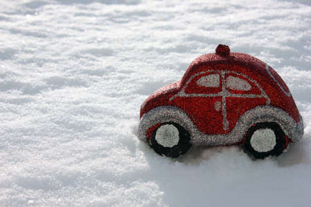 Christmas tree toys in the form of a red car on a white background. Christmas and New Year. Toys on the Christmas tree. Childhood. Copy space. New Year is decoration, symbol, gift. Giftの写真素材