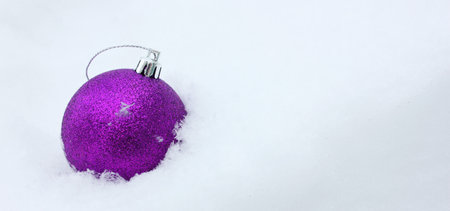 Christmas tree toys purple ball on a white background.. Christmas and New Year. Toys on the Christmas tree. Childhood. Copy space. New Year is decoration, symbol, gift. The ball lies on the snowの写真素材