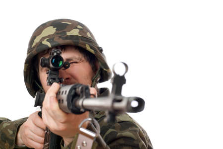 Soldier aiming a rifle in studio. Isolatedの写真素材