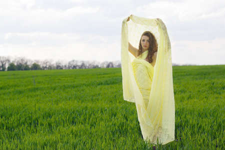 Perfect young woman wrapped in yellow cloth