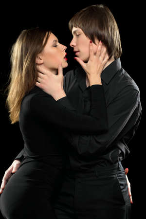 Portrait of a young sensual loving couple. Isolated on black