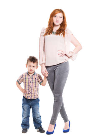 Young redhead woman posing with her little son. Isolated on whiteの写真素材