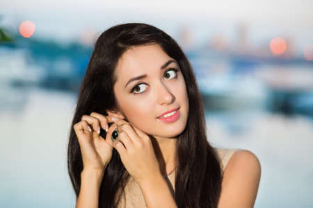 Portrait of smiling brunette wearing earring outdoorsの写真素材
