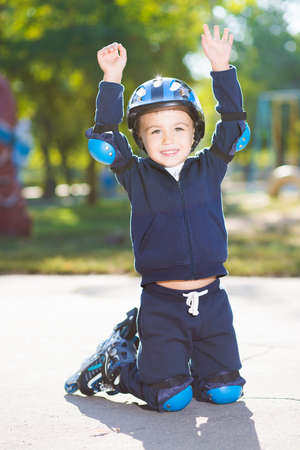 Playful little boy posing on the knee pads
