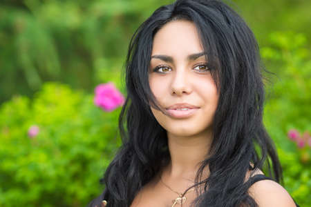 Portrait of pretty young brunette posing outdoorsの写真素材