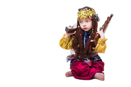 Little boy wearing like a pirate posing with two guns. Isolated on whiteの写真素材