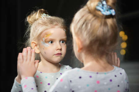 Little surprised girl in the mirror
