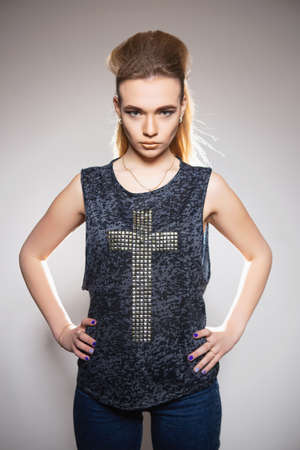 Cute young blonde posing in studio with hairdo and makeupの写真素材