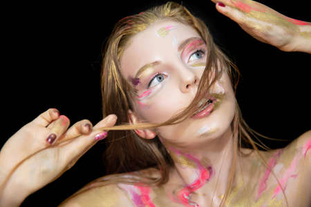 Portrait of a pretty young woman with creative make up on her face