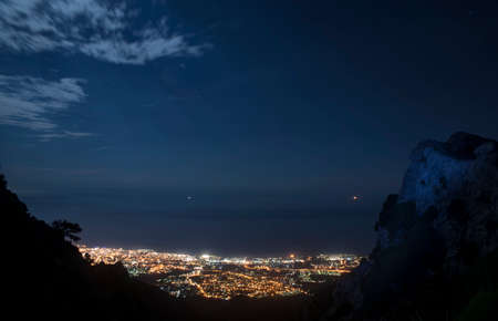 Beautiful night view of Marbella from the altitude of the mountainの写真素材