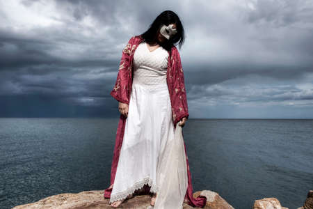 Woman covering her face with a white maskの写真素材