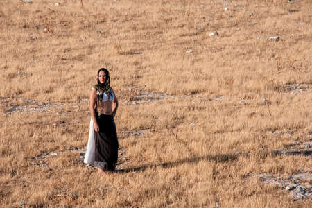 Pretty Woman with arabic in a dry field