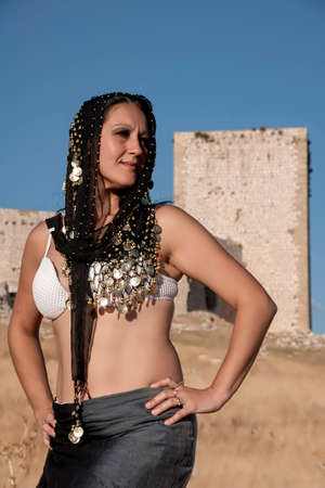 Moorish woman next to an old castleの写真素材