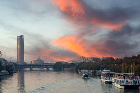 sunset on the guadalquivir river as it passes through the city of Seville, Spainのeditorial素材