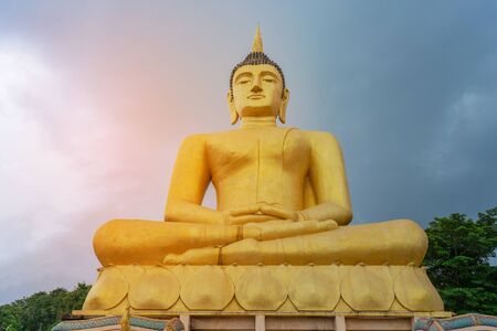 The big golden Buddha statue of Phu Salao temple with Mekong River flows through the Pakse city in...